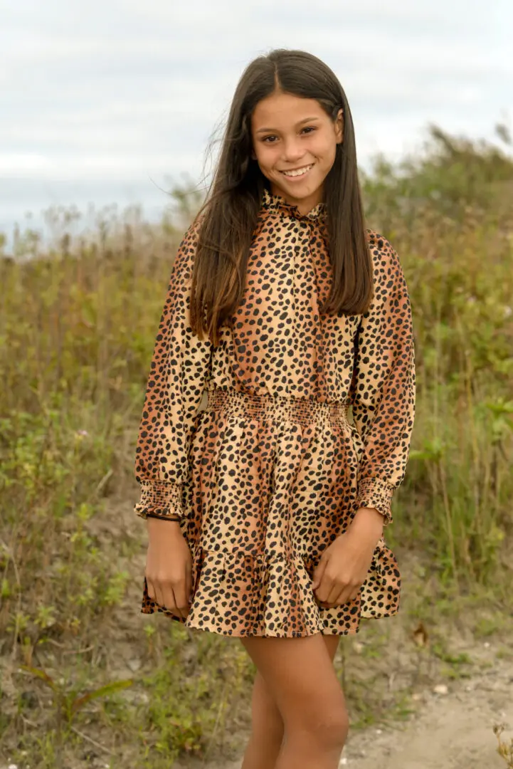 Girl wearing a tiger dress, smiling at the camera
