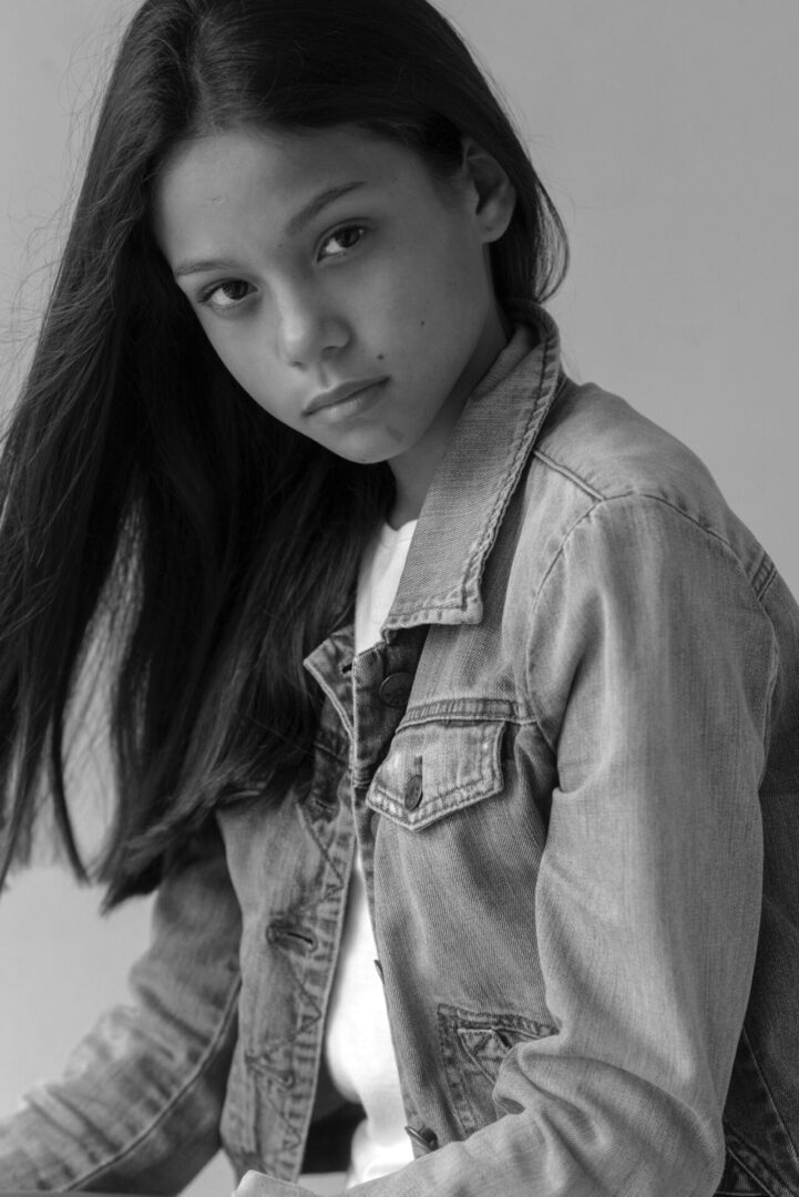 Black and white image of a girl posing at the camera