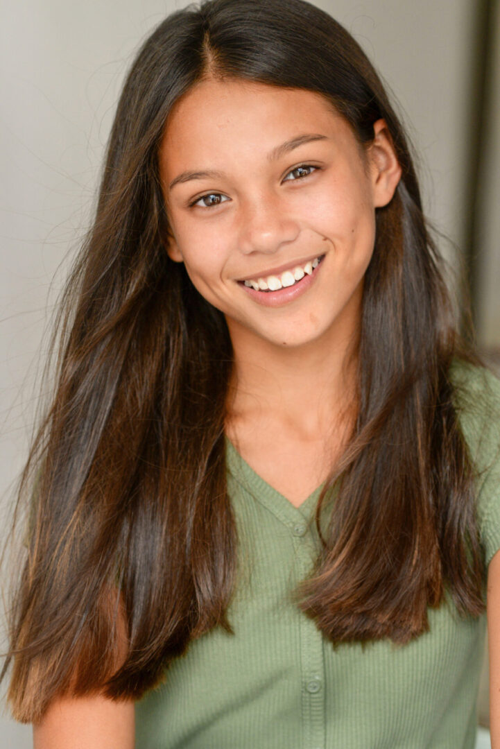 Caroline Quinn wearing a green top and smiling