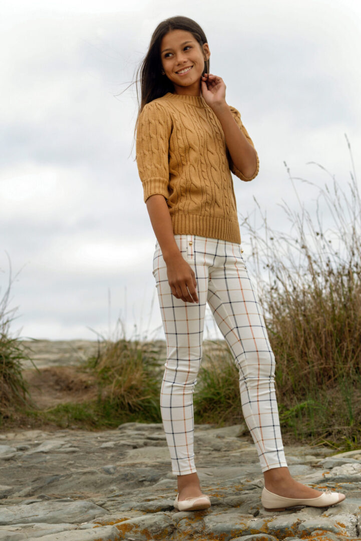 Caroline Quinn standing on a rock and smiling