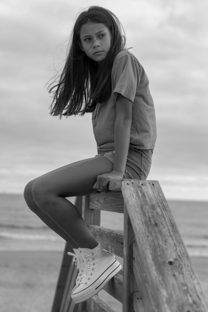 Caroline Quinn sitting on a wooden panel