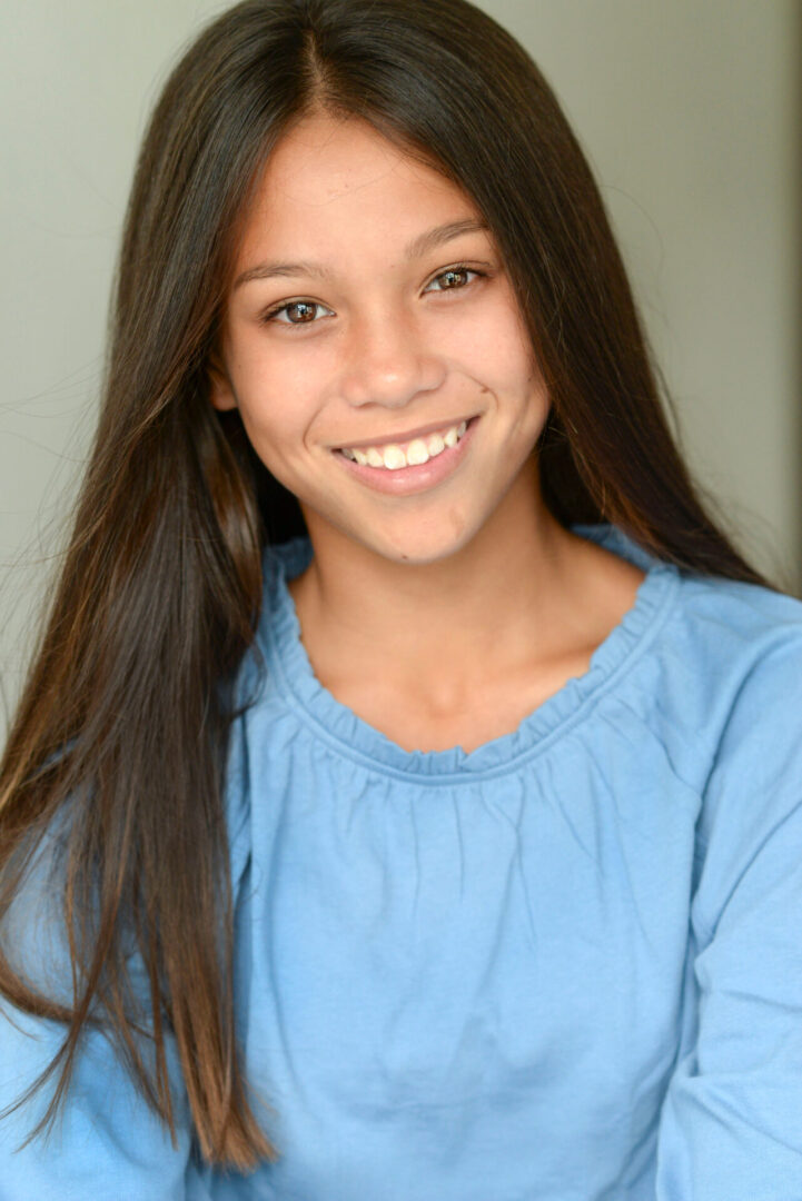 Caroline Quinn wearing a blue top and smiling