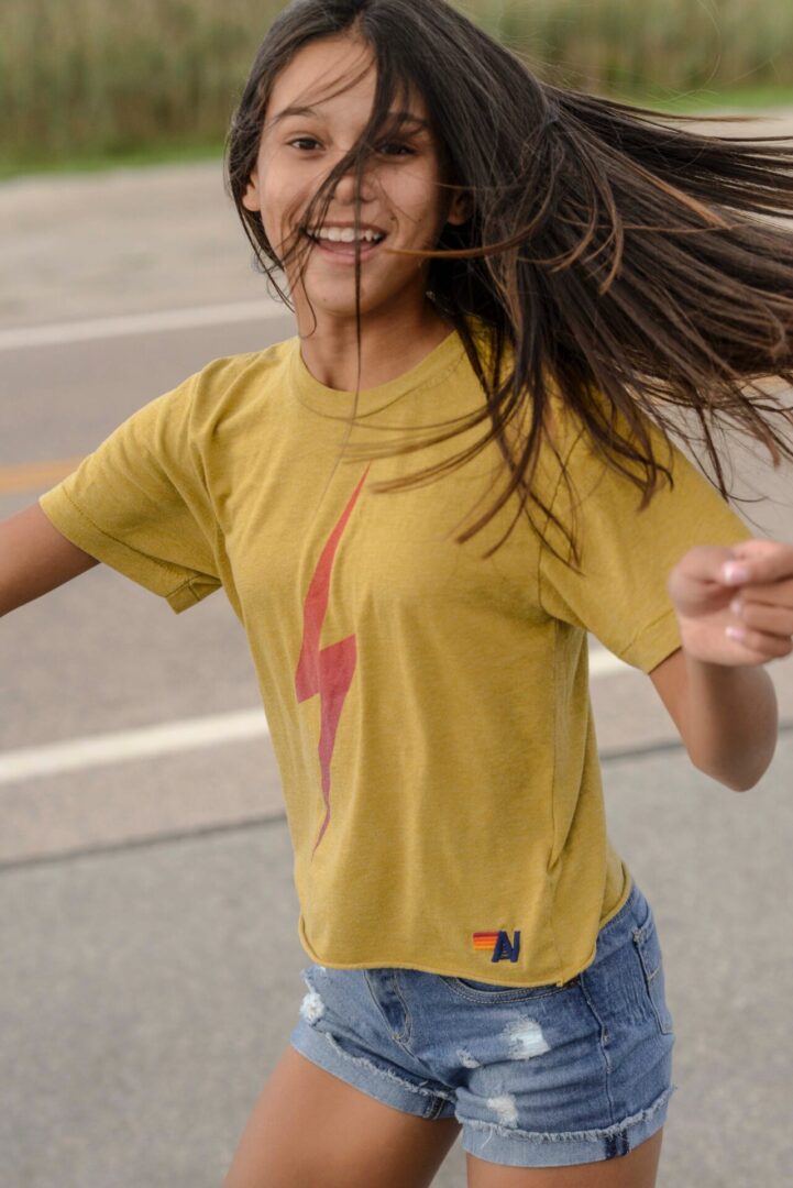 Caroline Quinn wearing yellow shirt and playing