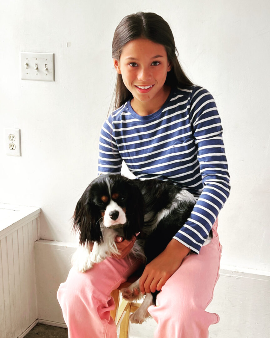 Caroline Quinn sitting and holding dog